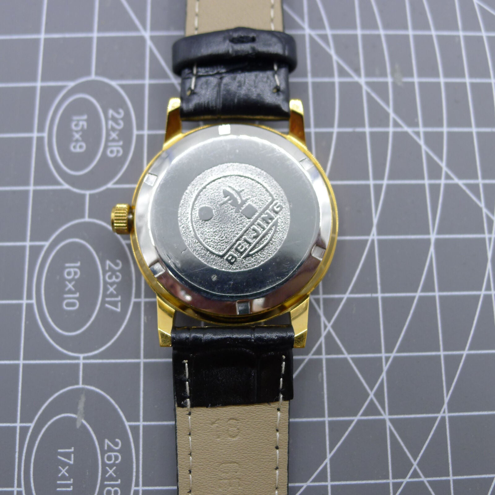 Beijing Double Rhomb watch with golden case, silver nail markers, manual movement for timeless elegance.