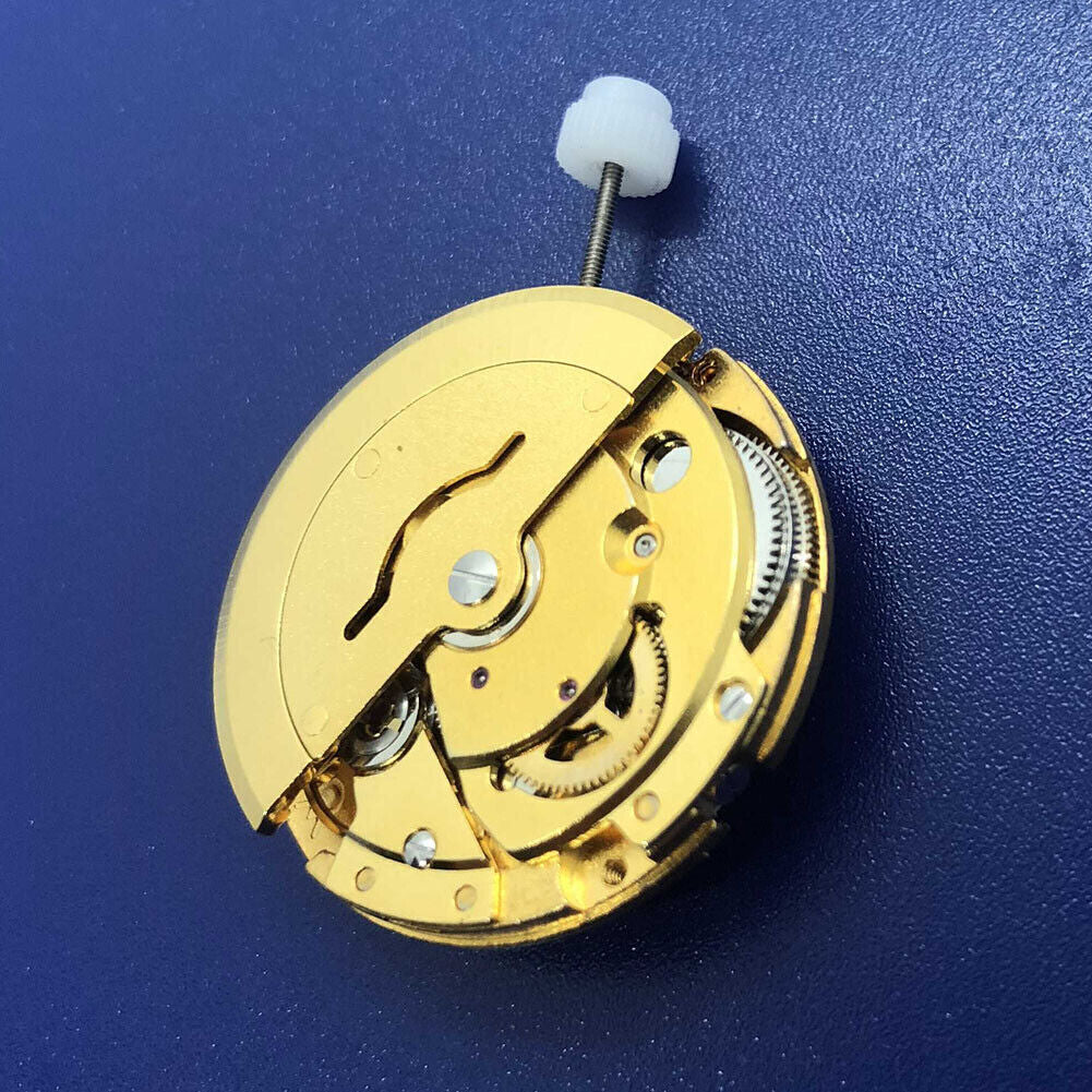 DG2813 automatic mechanical watch movement in gold finish, featuring day and date display for precise timekeeping.