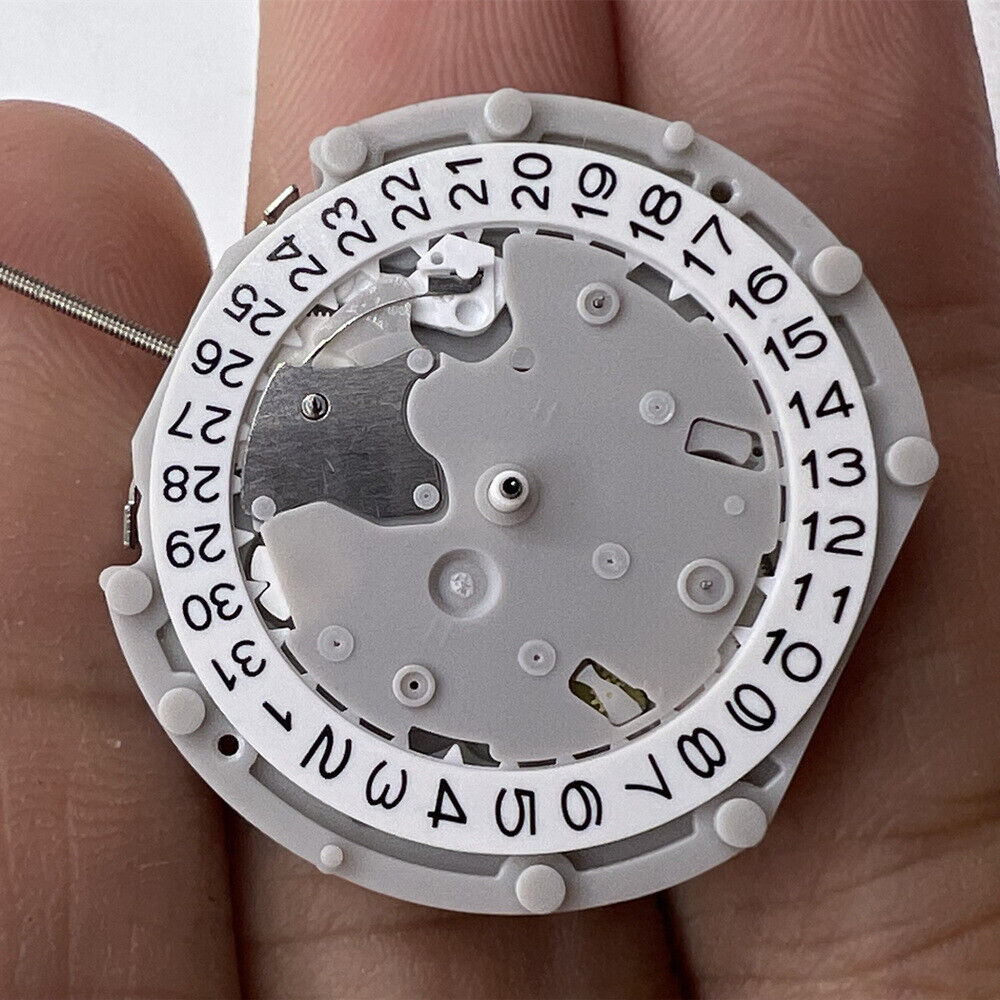 Sunon PE70 quartz watch movement with date at 3 and small seconds at 3, 6, and 9 o'clock positions