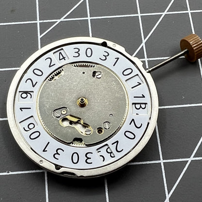 Swiss Made Ronda 6003B quartz watch movement with date display at 12 o'clock for precise timekeeping.