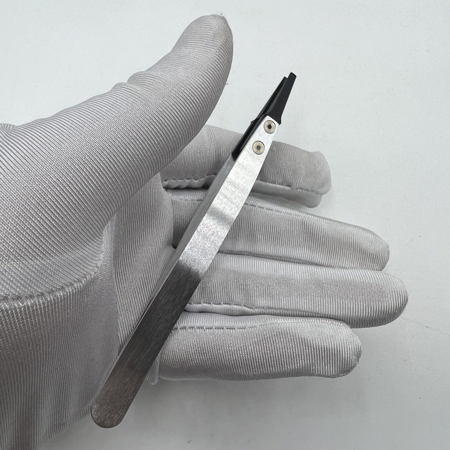 Swiss Made Horotec MSA12.711 carbon fibre tweezers with broad flat tips for precise watch accessory handling.