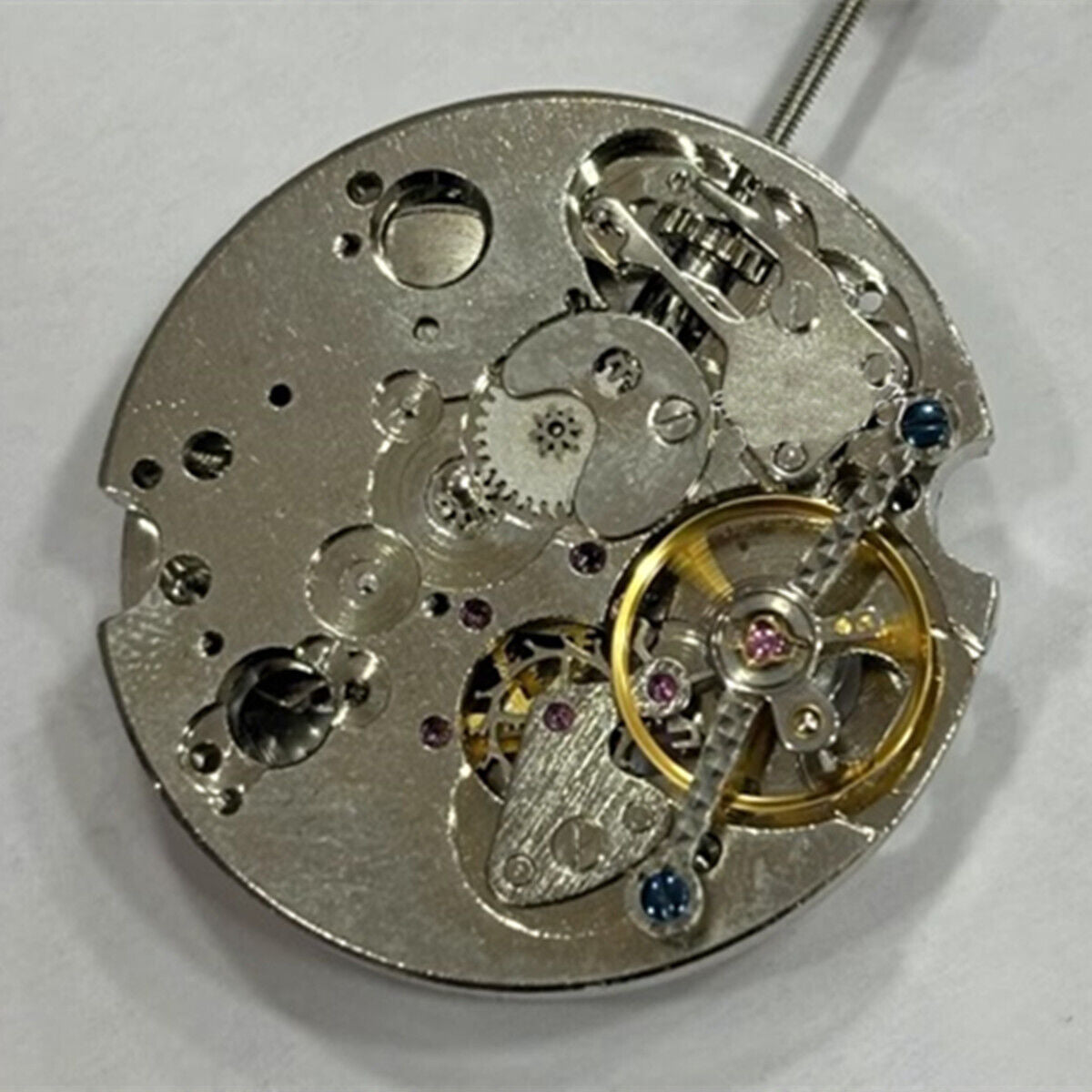 China Made watch with 2 hands and automatic mechanical movement, featuring a bare balance wheel at 6 o'clock.