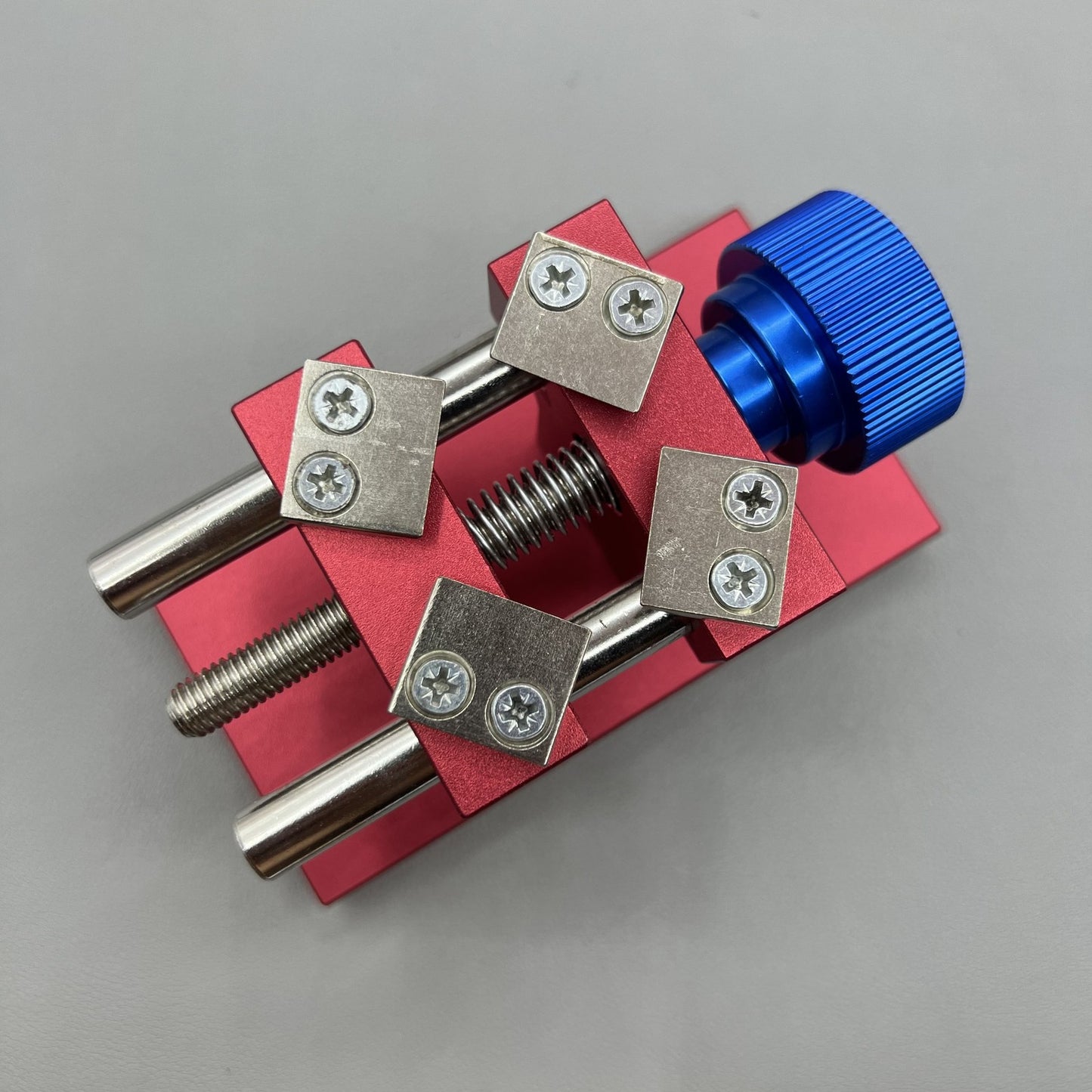 Professional watch bezel remover and case back opener tool for precise watch repair workbench.