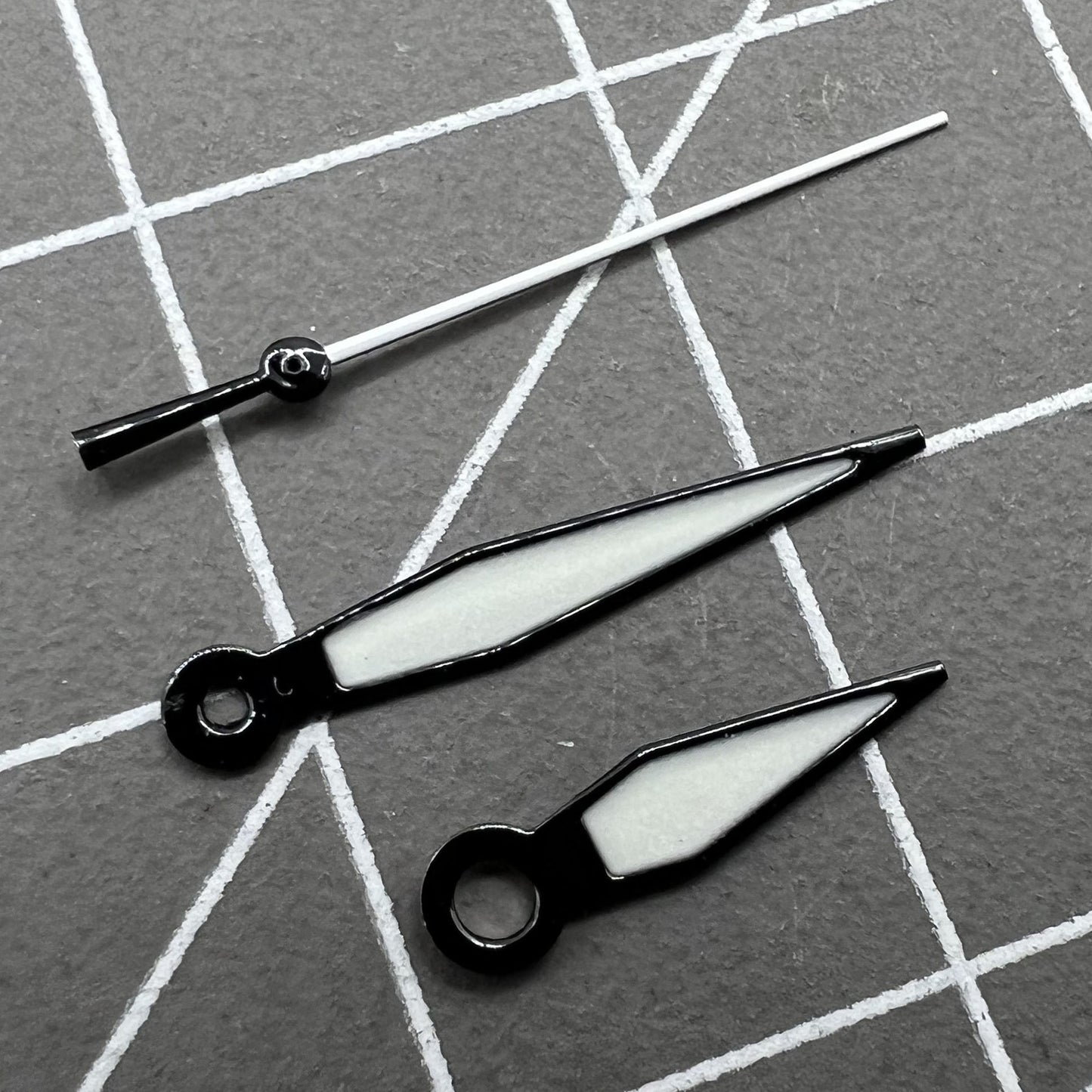 Black trimmed green luminous watch hands set for NH35/NH36 movements, enhancing visibility and precise time reading.