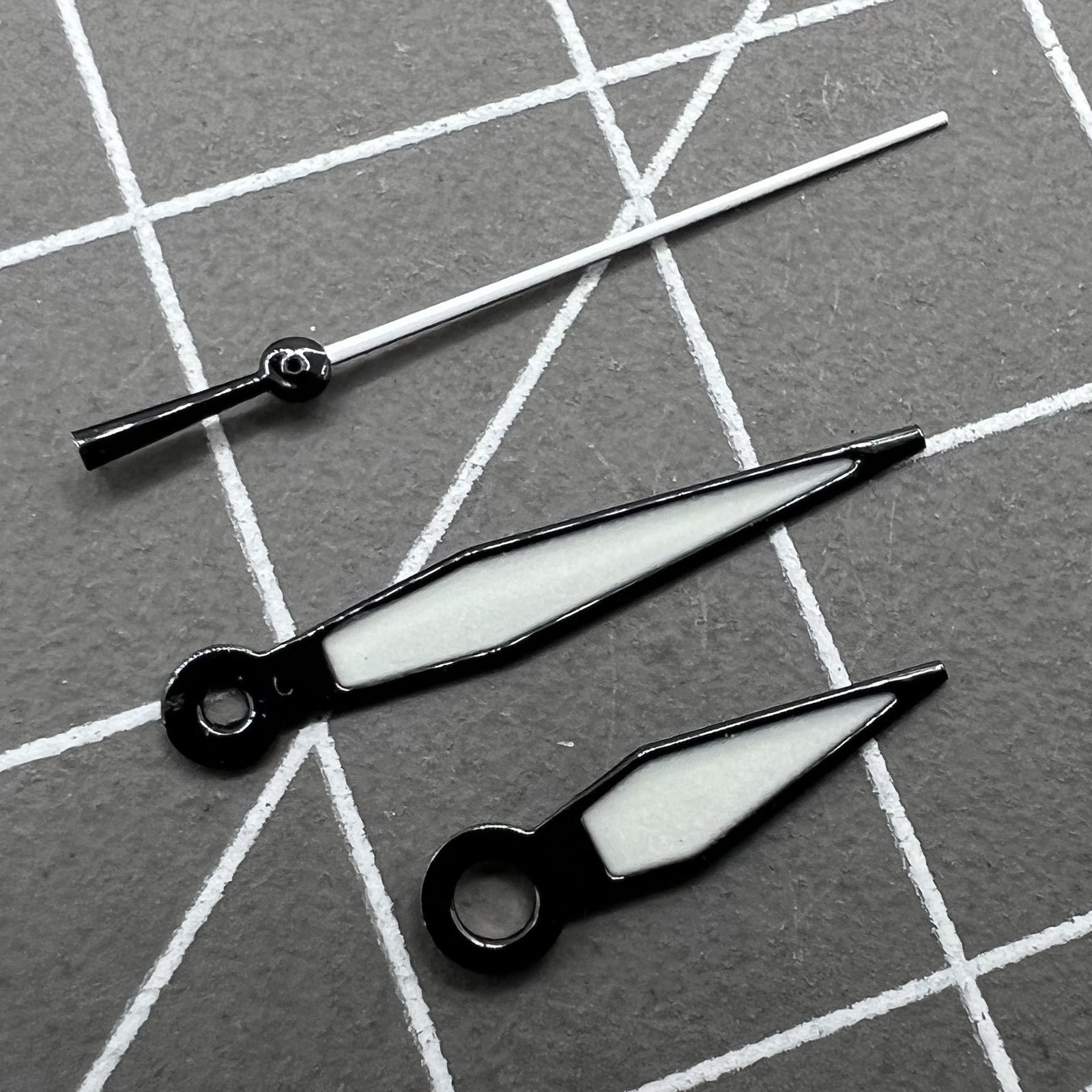 Black trimmed green luminous watch hands set for NH35/NH36 movements, enhancing visibility and precise time reading.