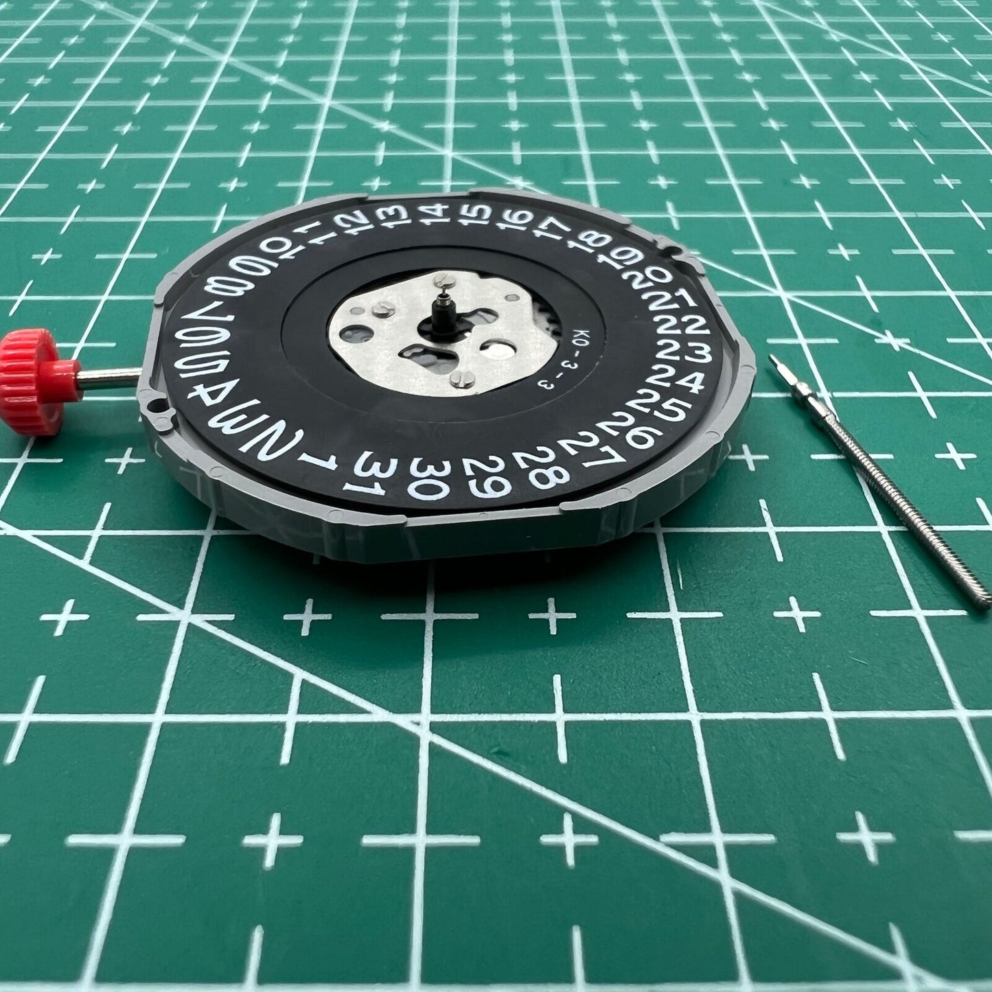 Miyota 2415 quartz movement with black date disk at 3 o'clock, Japan-made watch part by Miyota.