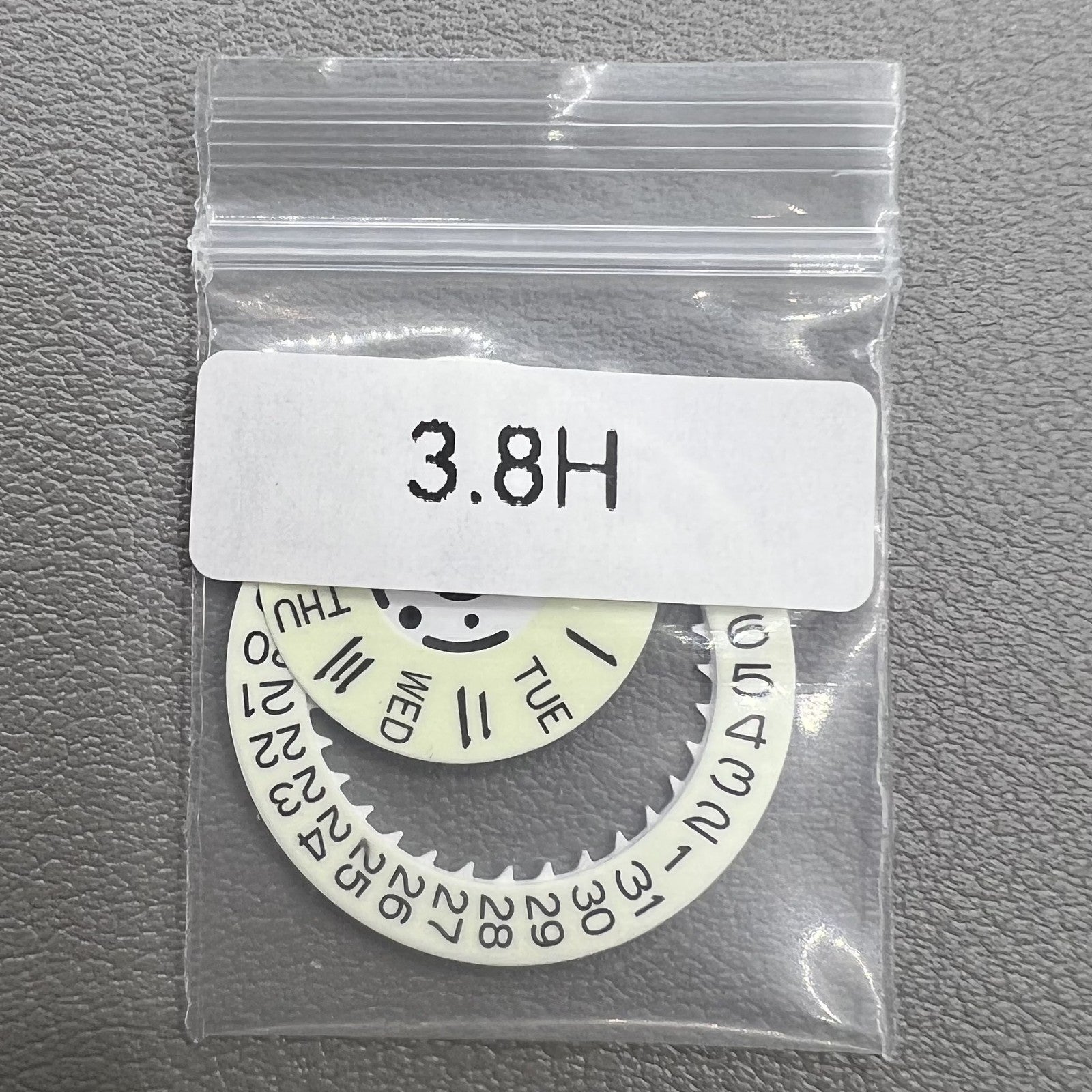 White date and week disk wheels with green lume, compatible with Seiko NH36 movement for watch customization.