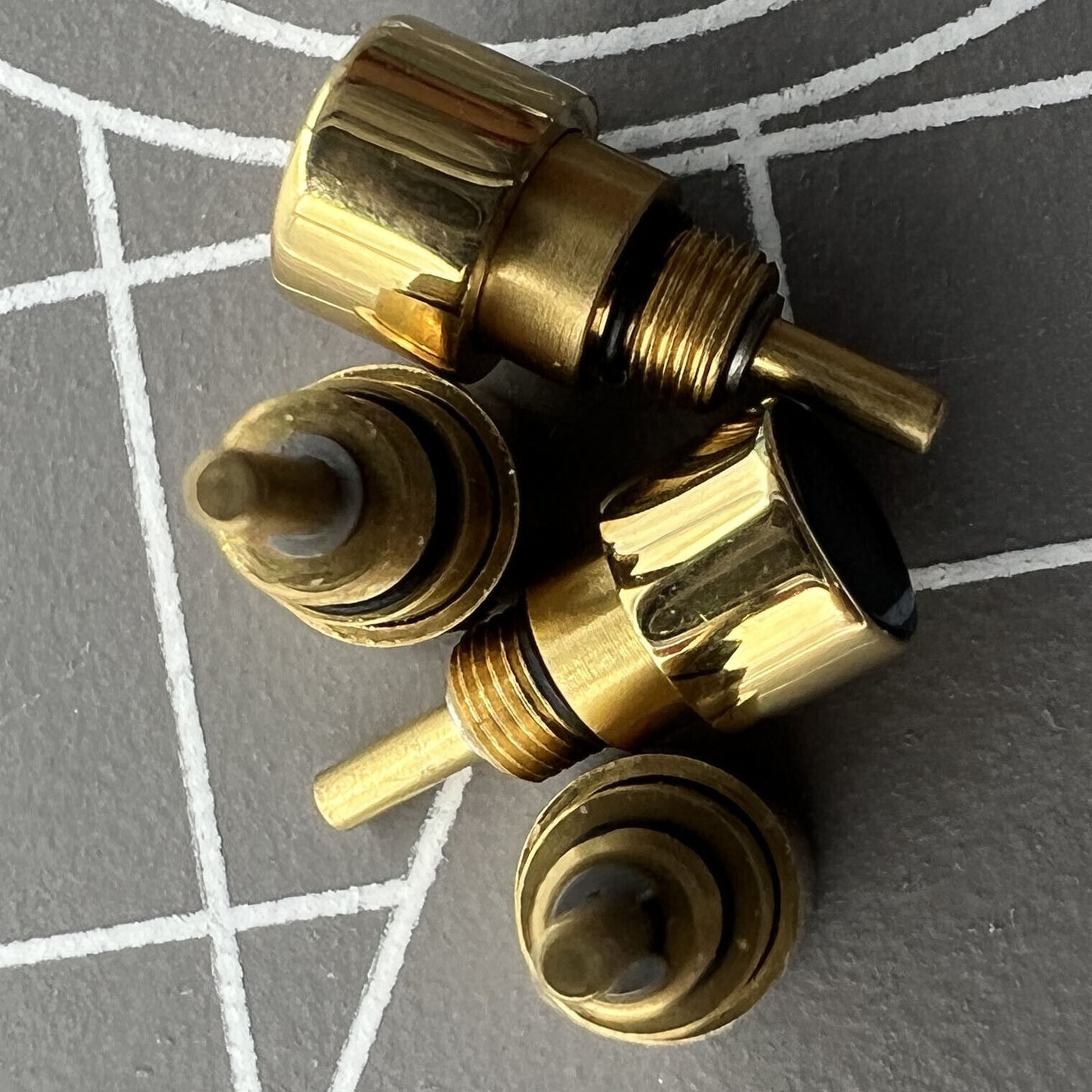 Set of 14 golden stainless steel watch pushers in 7 sizes, durable for classic drive-in repairs.