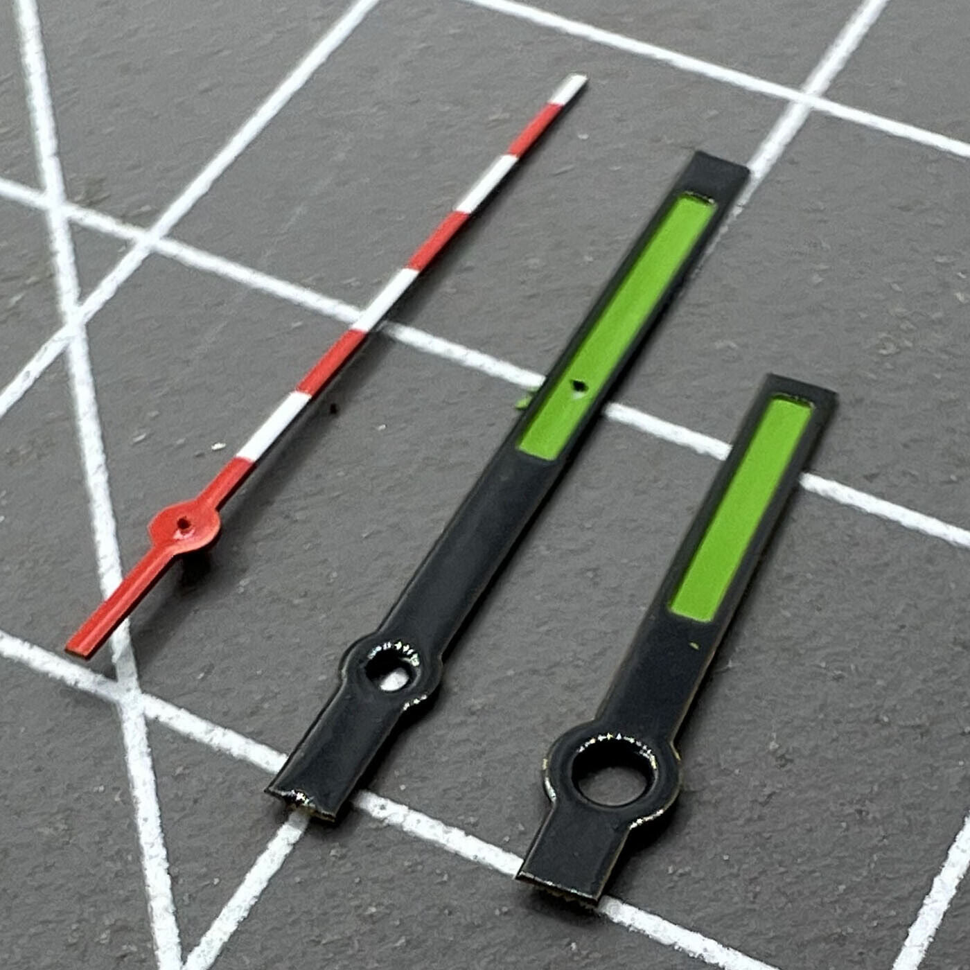 Green watch hands with black, red, and white trim for Ronda 515 quartz, designed for accurate timekeeping.