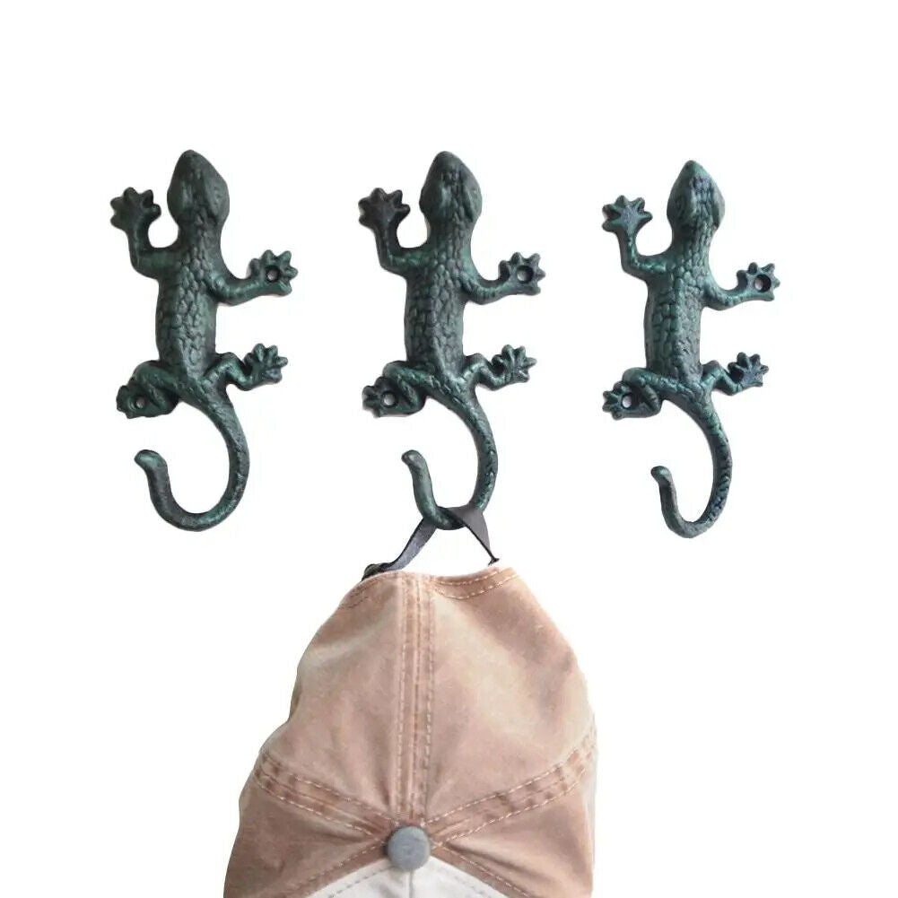 Vintage cast iron gecko wall hook, rustic design ideal for hanging cloth or garden tools.
