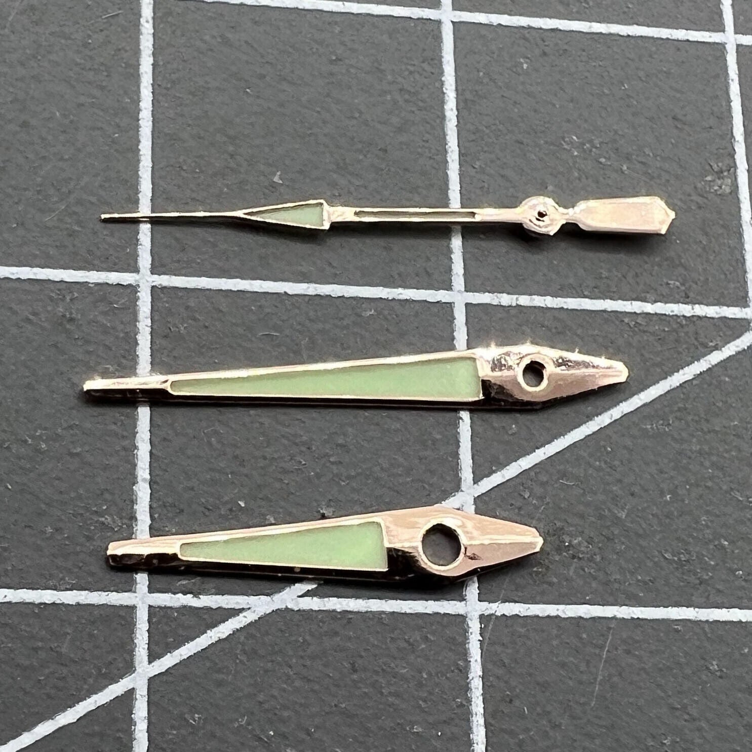 14mm rose gold arrow-shaped luminous watch hands for ISA 2331 with green glow, precise accessory.
