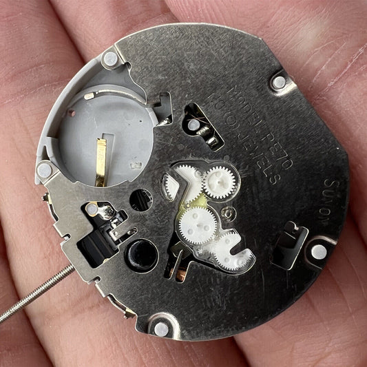 Sunon PE70 quartz watch movement with 3 hands and date display at 3 o'clock, small seconds at 6 and 9.