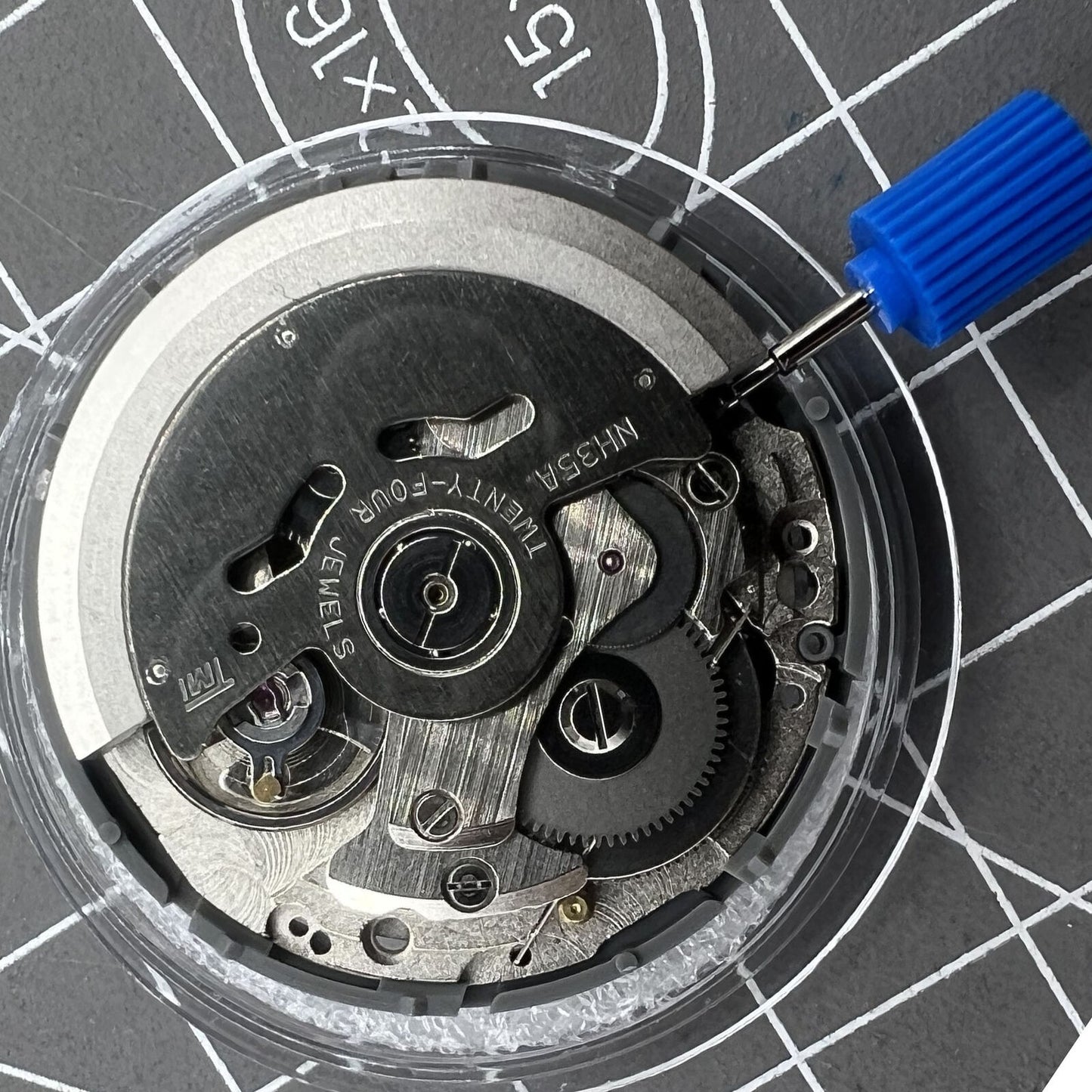 Black Seiko NH35 automatic watch movement with date at 6, precise self-winding mechanical mechanism.