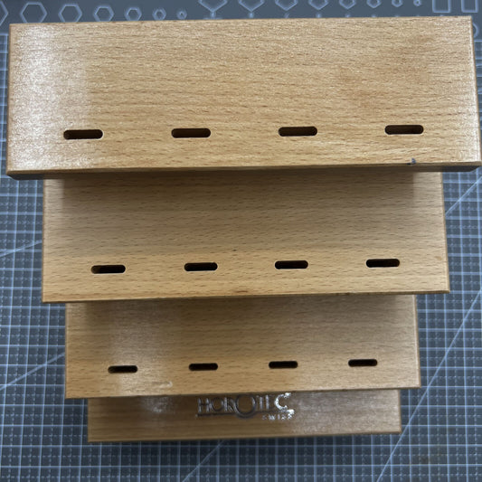 Swiss Horotec wooden storage rack holding 12 watchmaker tweezers, perfect for organized tool storage.
