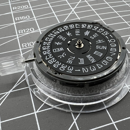 Miyota NH36A automatic watch movement with black finish, blue lume highlights, and crown positioned at 3/3.8 for precision.