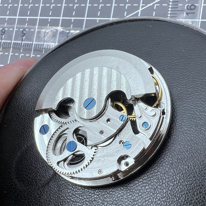 Small silver hollow watch movement with double mainspring and balance wheel at 6 o?clock by Kleines brand.