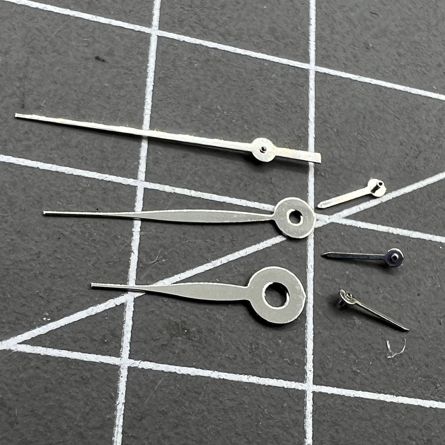 Silver 14mm arrow-shaped watch hands, no lume, compatible with Miyota 0S11 for precise timing.
