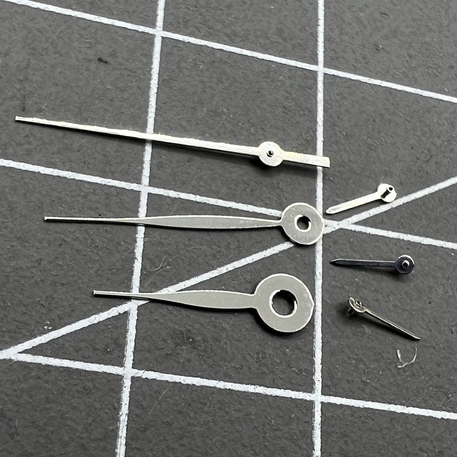 Silver 14mm arrow-shaped watch hands, no lume, compatible with Miyota 0S11 for precise timing.