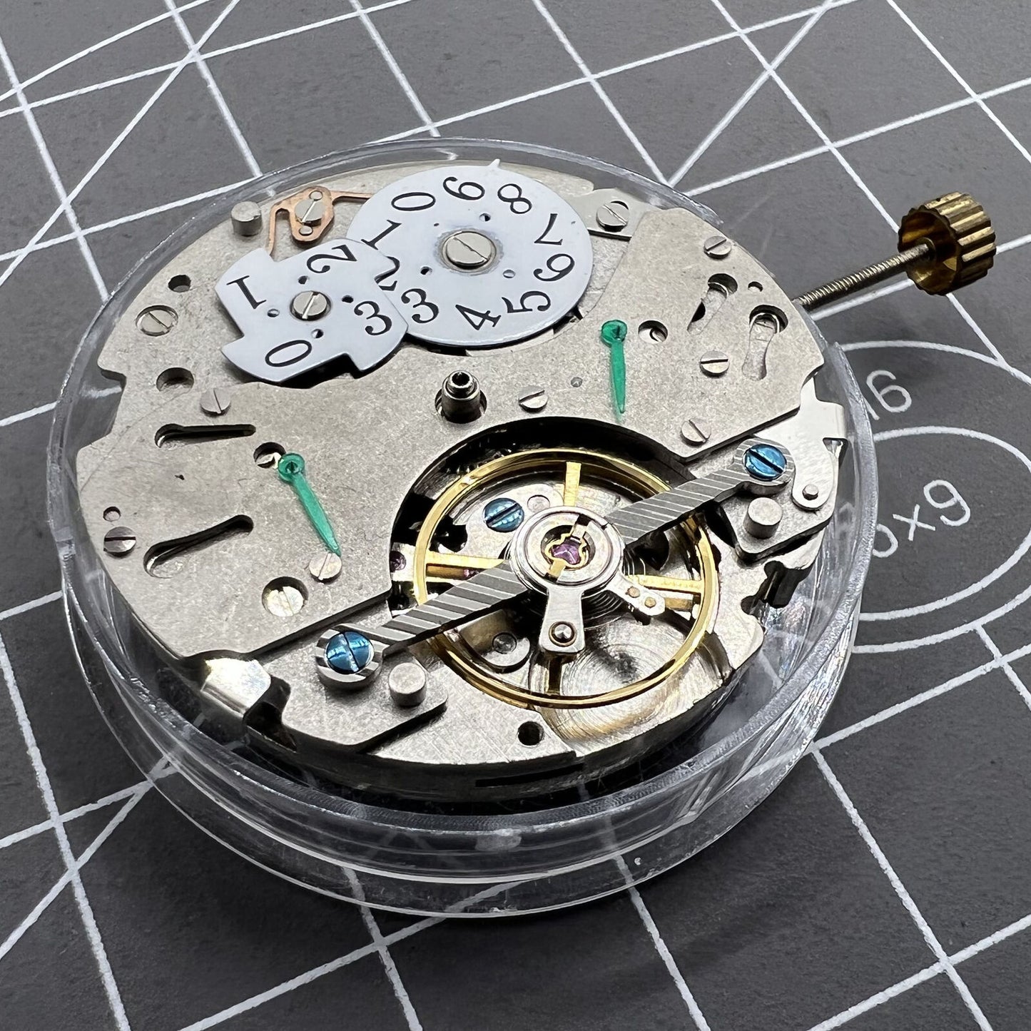 Automatic mechanical watch with reversed balance wheel, big date at 12, precision timekeeping.