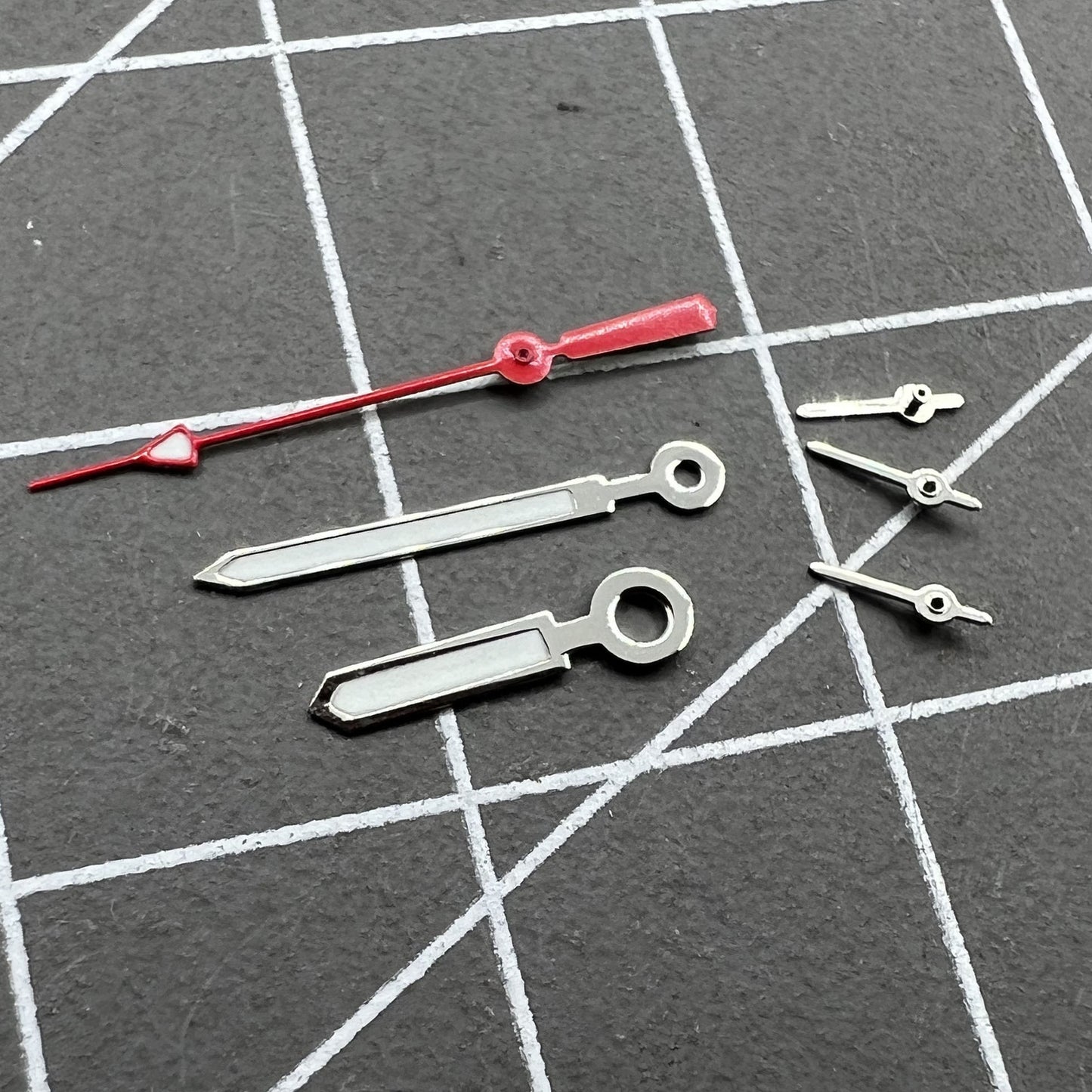 Set of 12mm watch hands with silver trim, red second hand, and green luminous for Miyota 0S10.