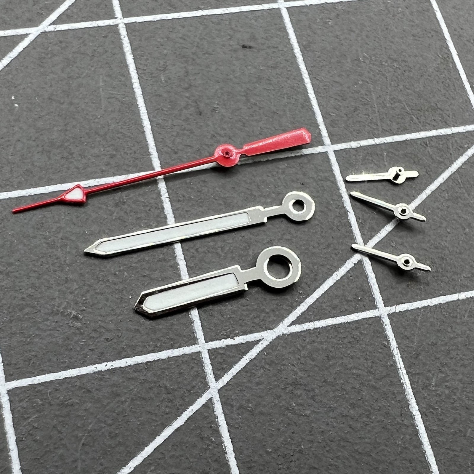 Set of 12mm watch hands with silver trim, red second hand, and green luminous for Miyota 0S10.