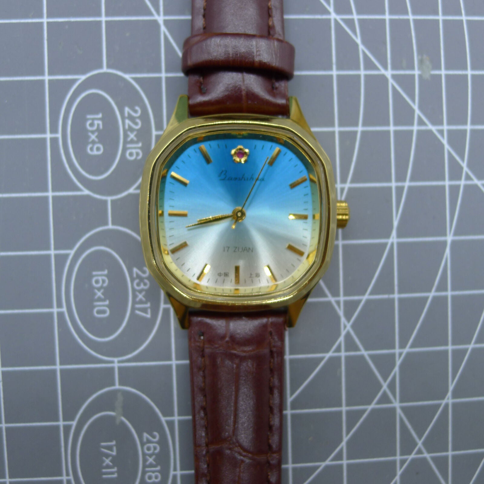 33mm Shanghai watch with blue dial, golden markers, square case, manual mechanical movement by Shanghai.