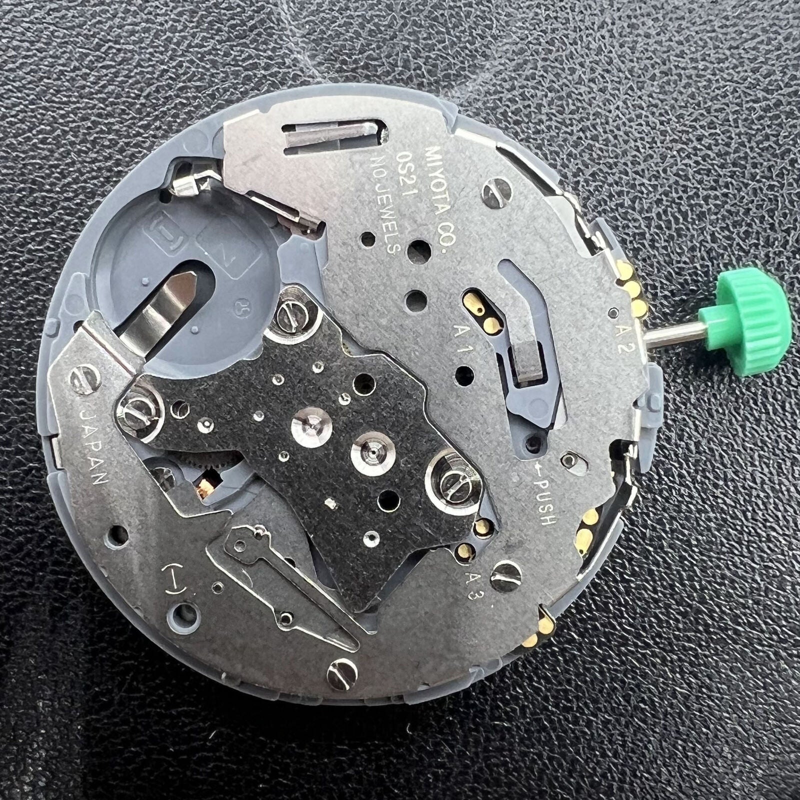 Miyota OS21 quartz watch movement with date at 6, Japan-made for accurate timekeeping and durability.