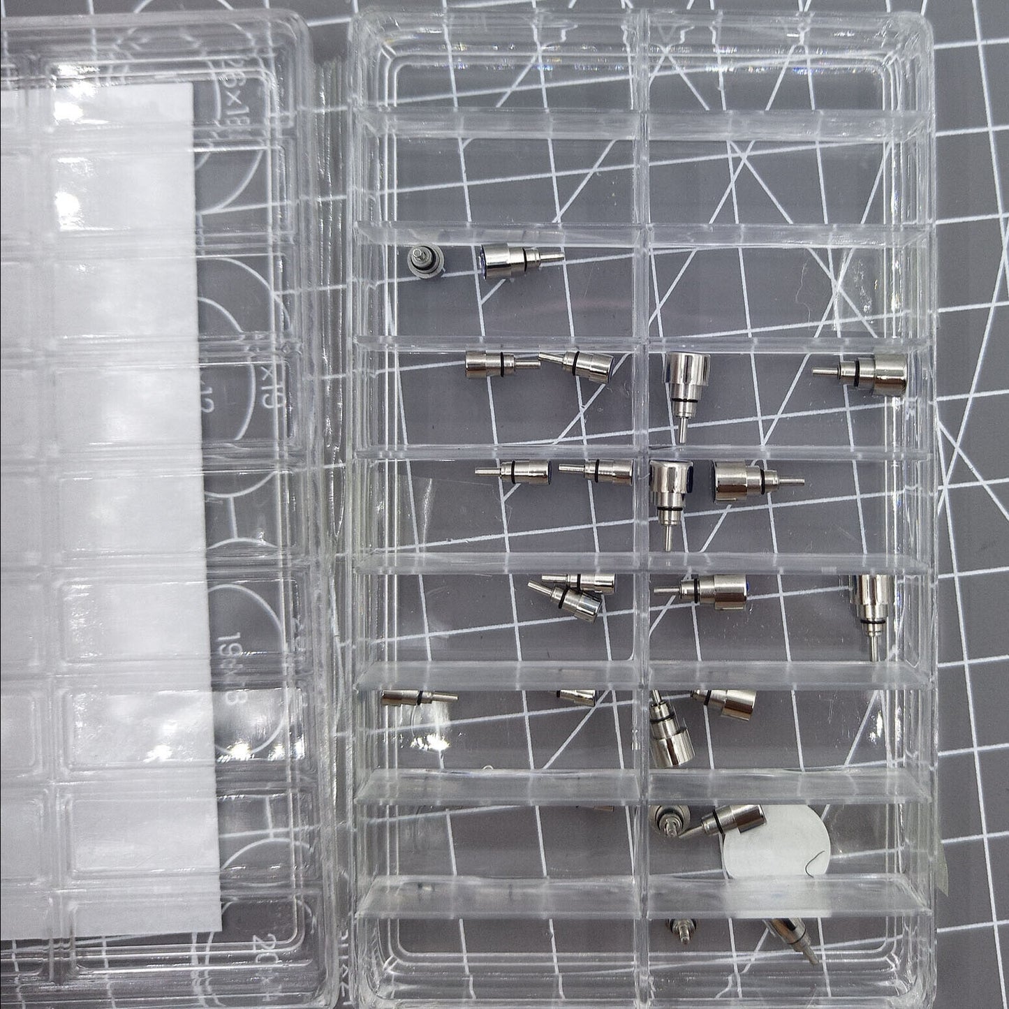 Set of 26 stainless steel chronograph and screw-in pushers for watch repairs and replacements.