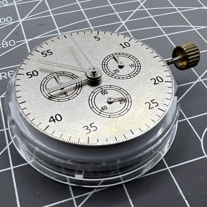 Close-up of China Made 7750 Automatic Chronograph Movement with ETA 7753 layout showing detailed gears at 3, 6, and 9 o'clock positions.