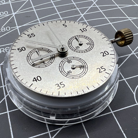 Close-up of China Made 7750 Automatic Chronograph Movement with ETA 7753 layout showing detailed gears at 3, 6, and 9 o'clock positions.