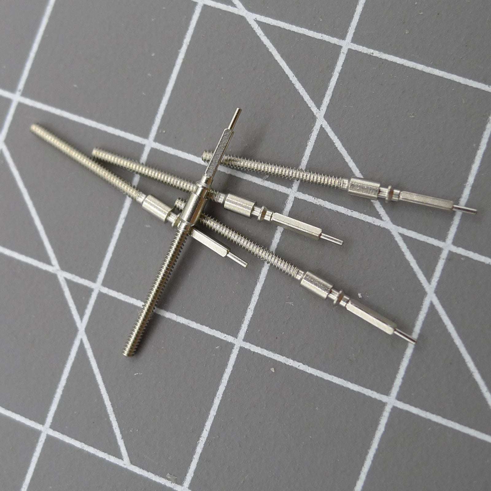 Set of 5 TY2502-2505 replacement watch winding stems for precise watch repair and movement compatibility.