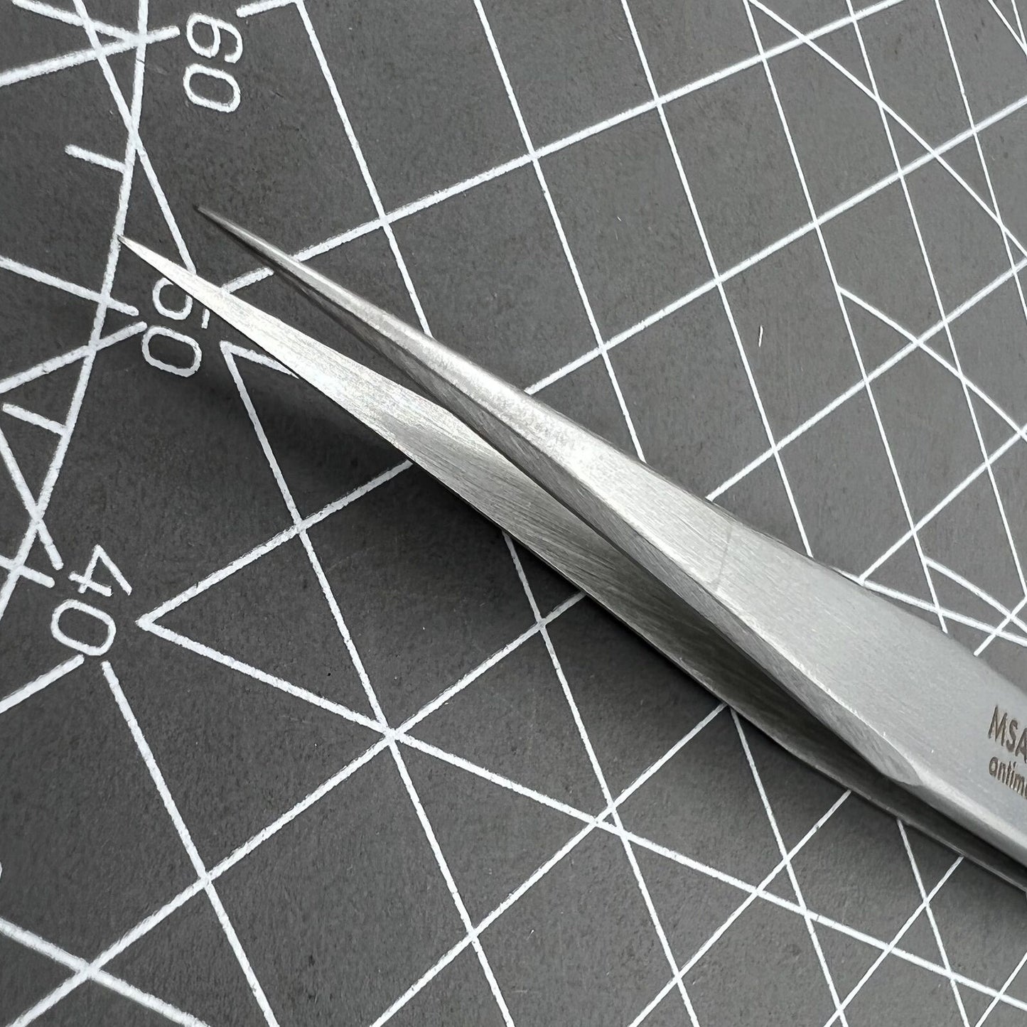 Swiss Horotec MSA12.302-3 antimagnetic fine tweezers for precise hairspring handling in watch repairs.