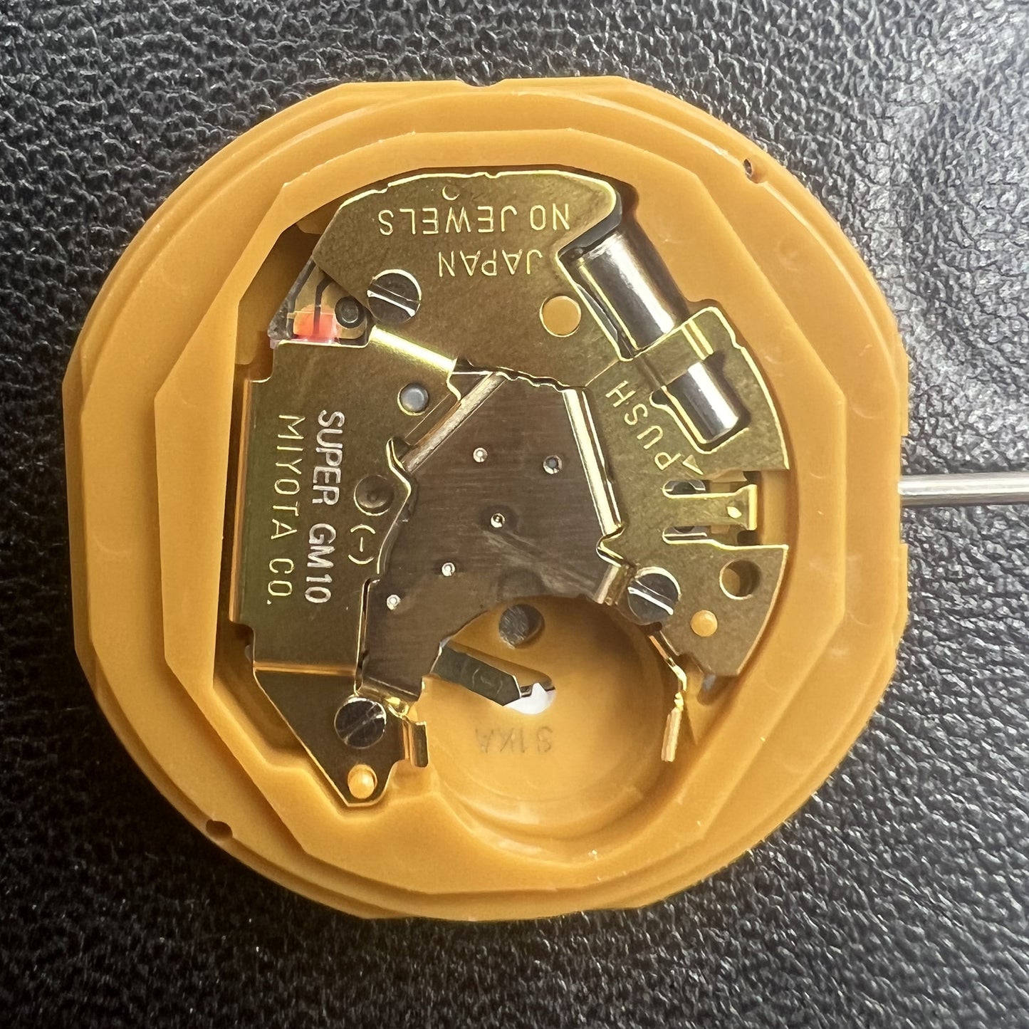 Japan Miyota GM10 watch movement with date display at 6 o'clock, precise quartz mechanism.