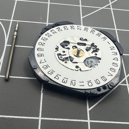 Hattori Epson TMI VX3K quartz watch movement with date at 3, Japan-made precision mechanism for repairs.