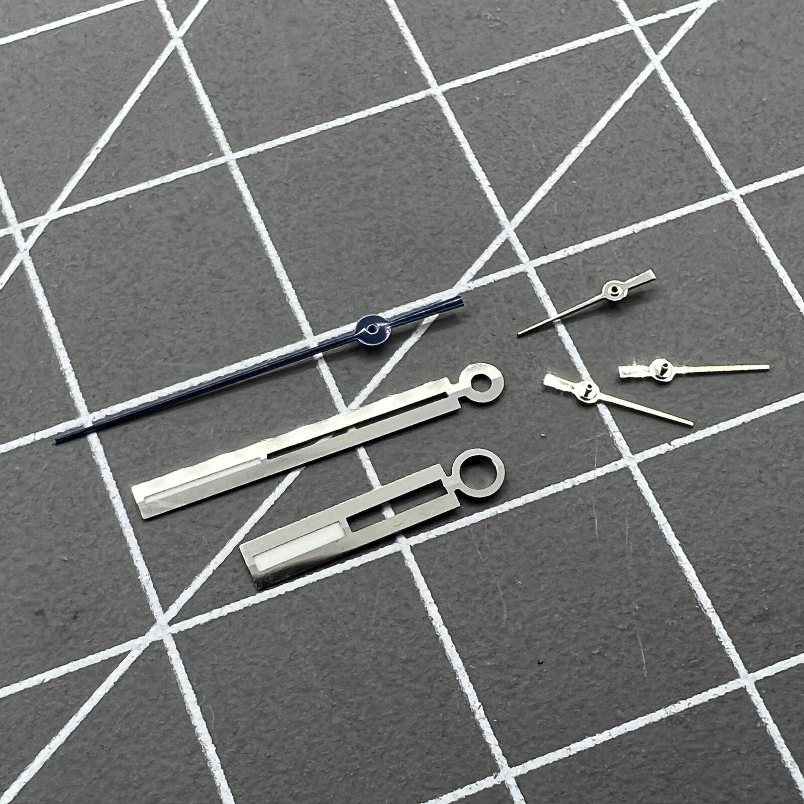 Luminous silver watch hands for Ronda 5021D quartz, perfect for accurate watch repairs and upgrades.