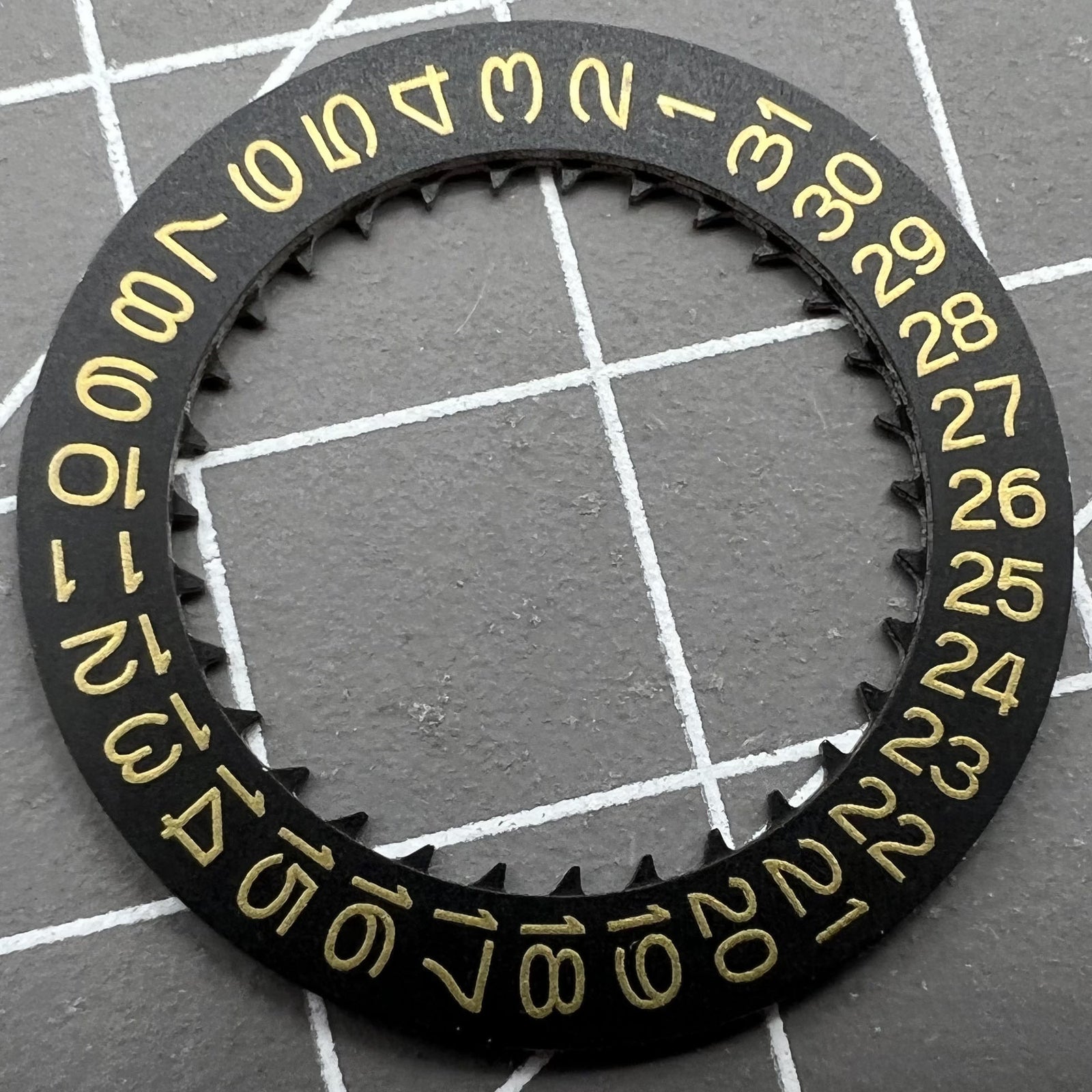 Golden Character date wheel on black background for NH35 NH36 watch movement, enhancing time display accuracy.