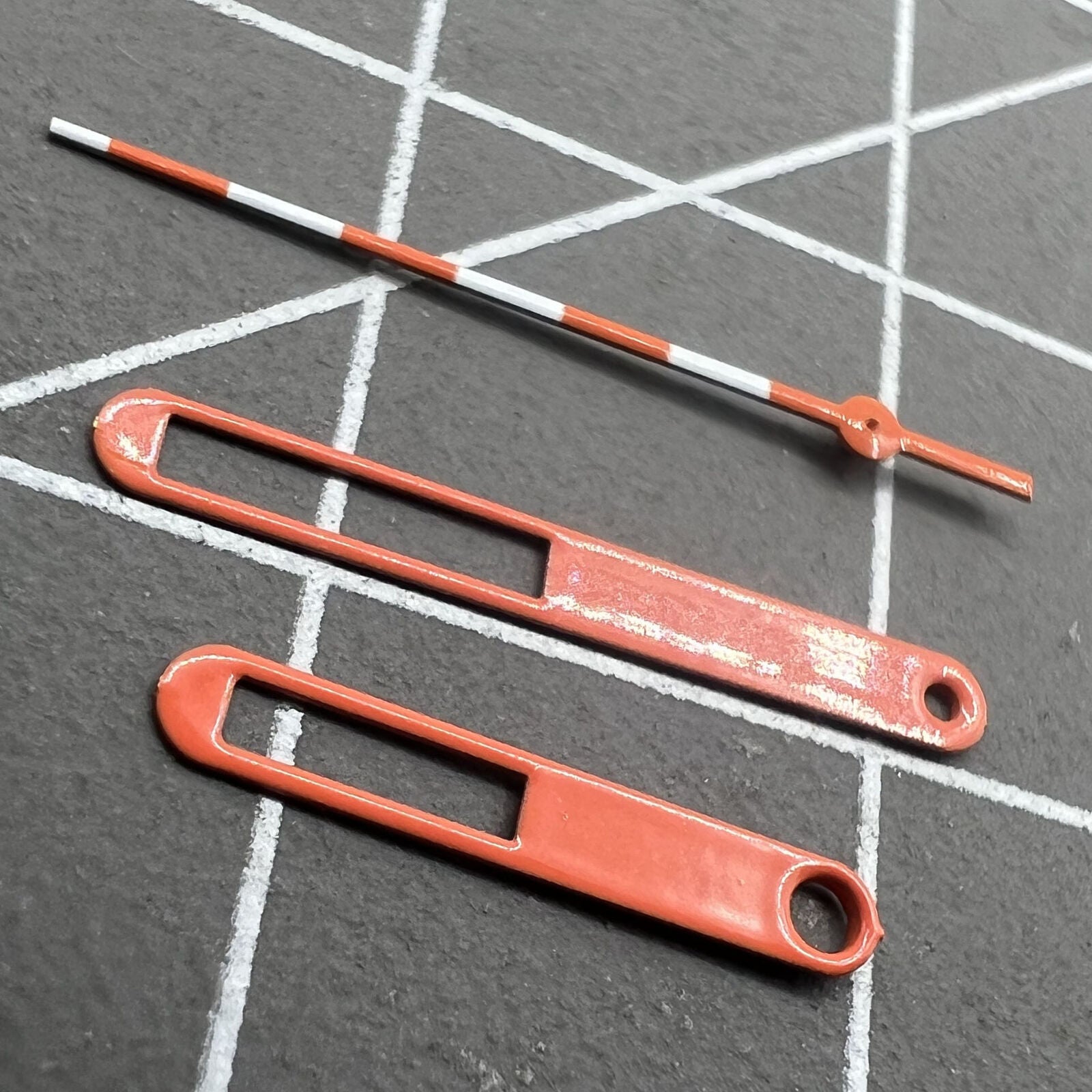 Orange and white watch hands with red trim for Ronda 515 quartz movement, 15mm set perfect for precise timekeeping upgrades.