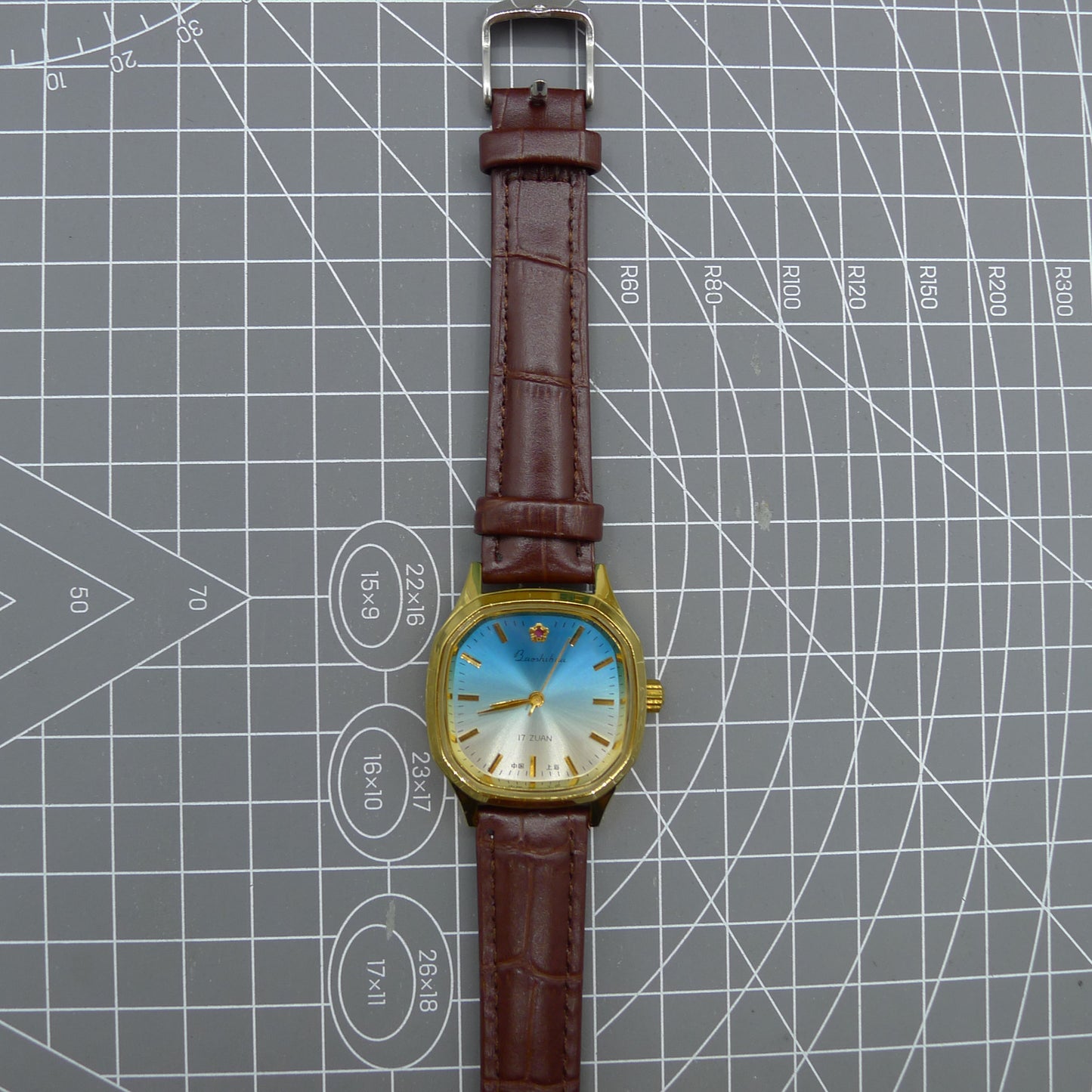 Shanghai 33mm manual mechanical watch with blue dial, gold markers, square case, 17 jewels movement for classic style.