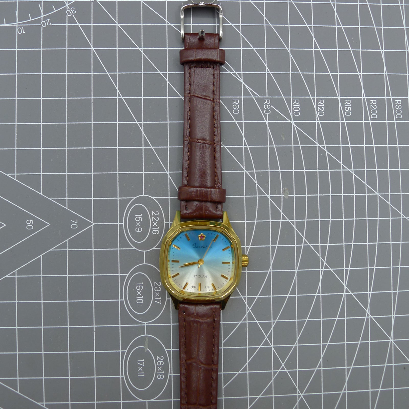 Shanghai 33mm manual mechanical watch with blue dial, gold markers, square case, 17 jewels movement for classic style.