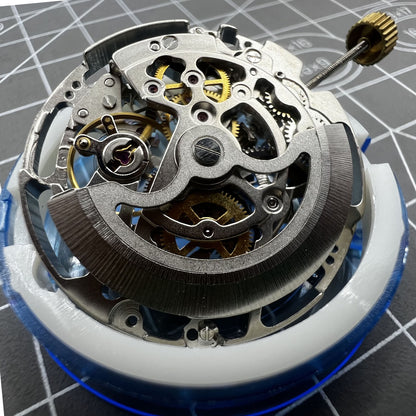 Dandong Silver watch accessory displaying hollow automatic mechanical movement with second stop function for precision.