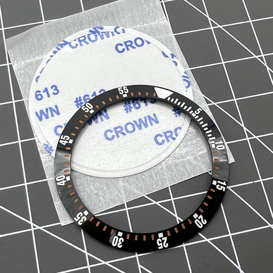 38mm black ceramic watch bezel insert with orange graduation for precise time tracking, compatible with various watch models.