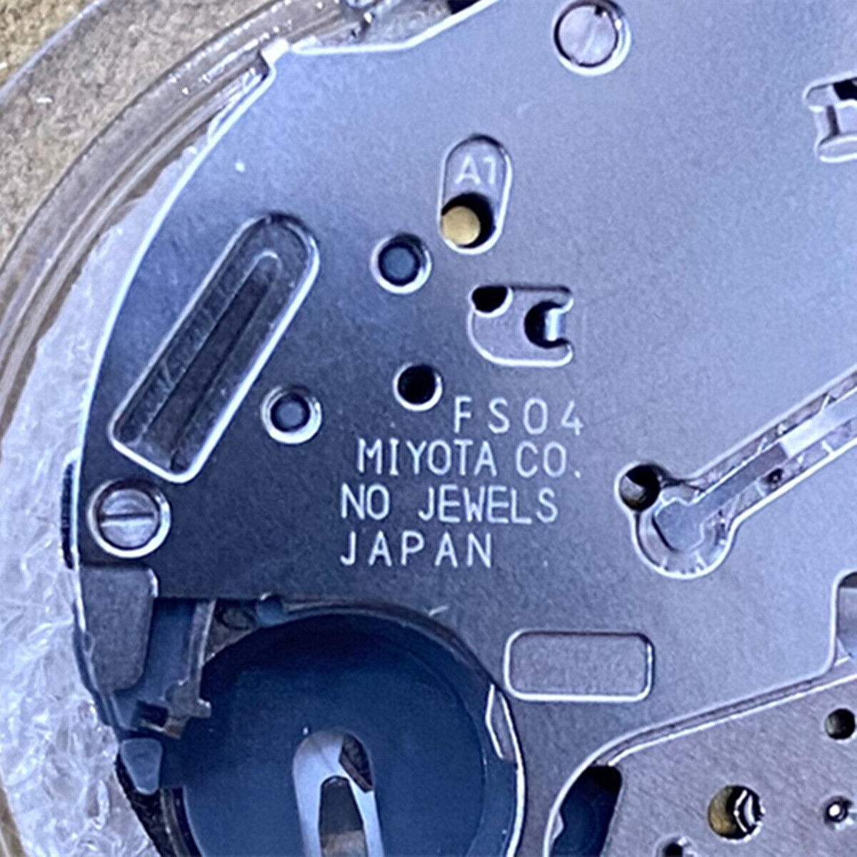 Miyota FS04 quartz watch movement showing multifunction calendar and small second features for precise timekeeping.