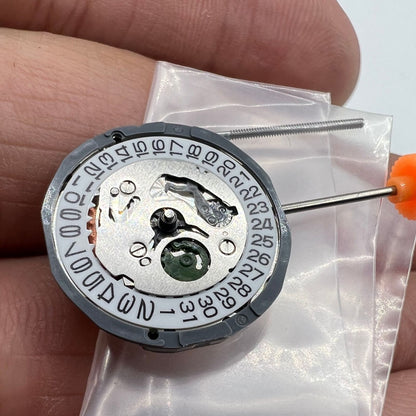 Miyota 1L15 Japan Quartz watch movement with date display at 3 o'clock, precise timekeeping mechanism.