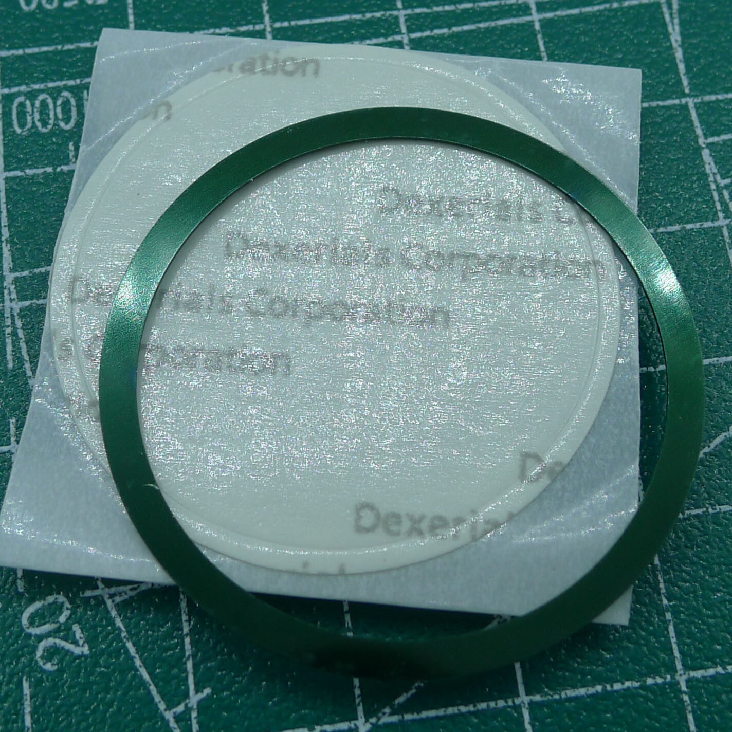 Green 38.5mm aluminum alloy bezel with white font for Omega Speedmaster, enhancing watch durability.