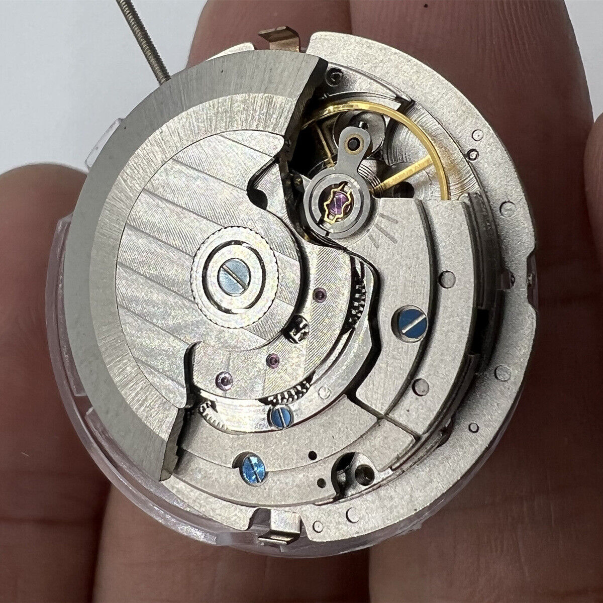 China Made Mechanical Automatic watch with 3 hands, big date at 12, and multi-function dial features.