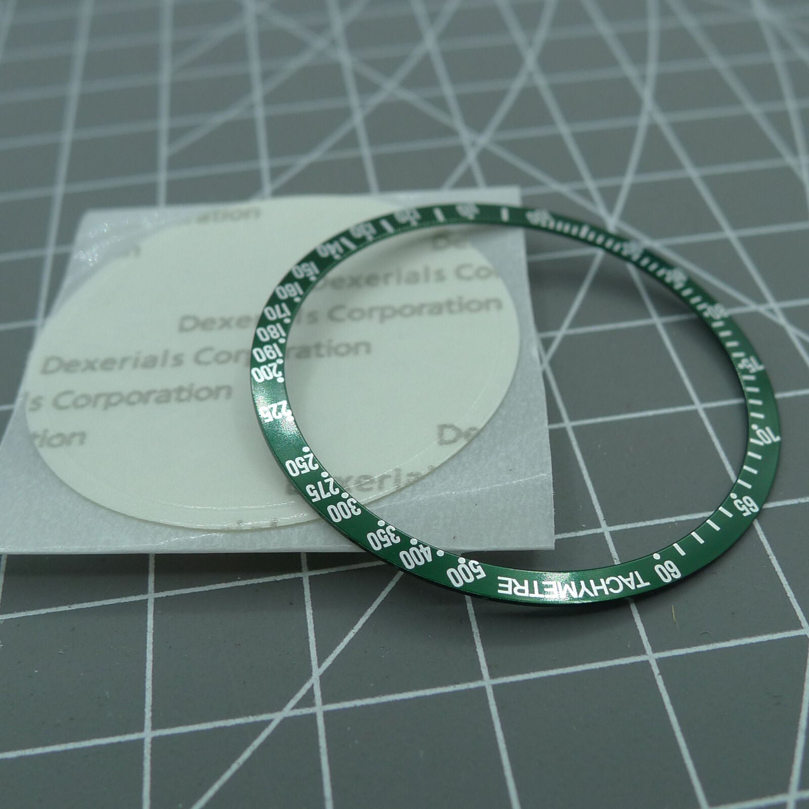 Green 38.5mm aluminum bezel with white font for Omega Speedmaster, enhancing watch durability and style.