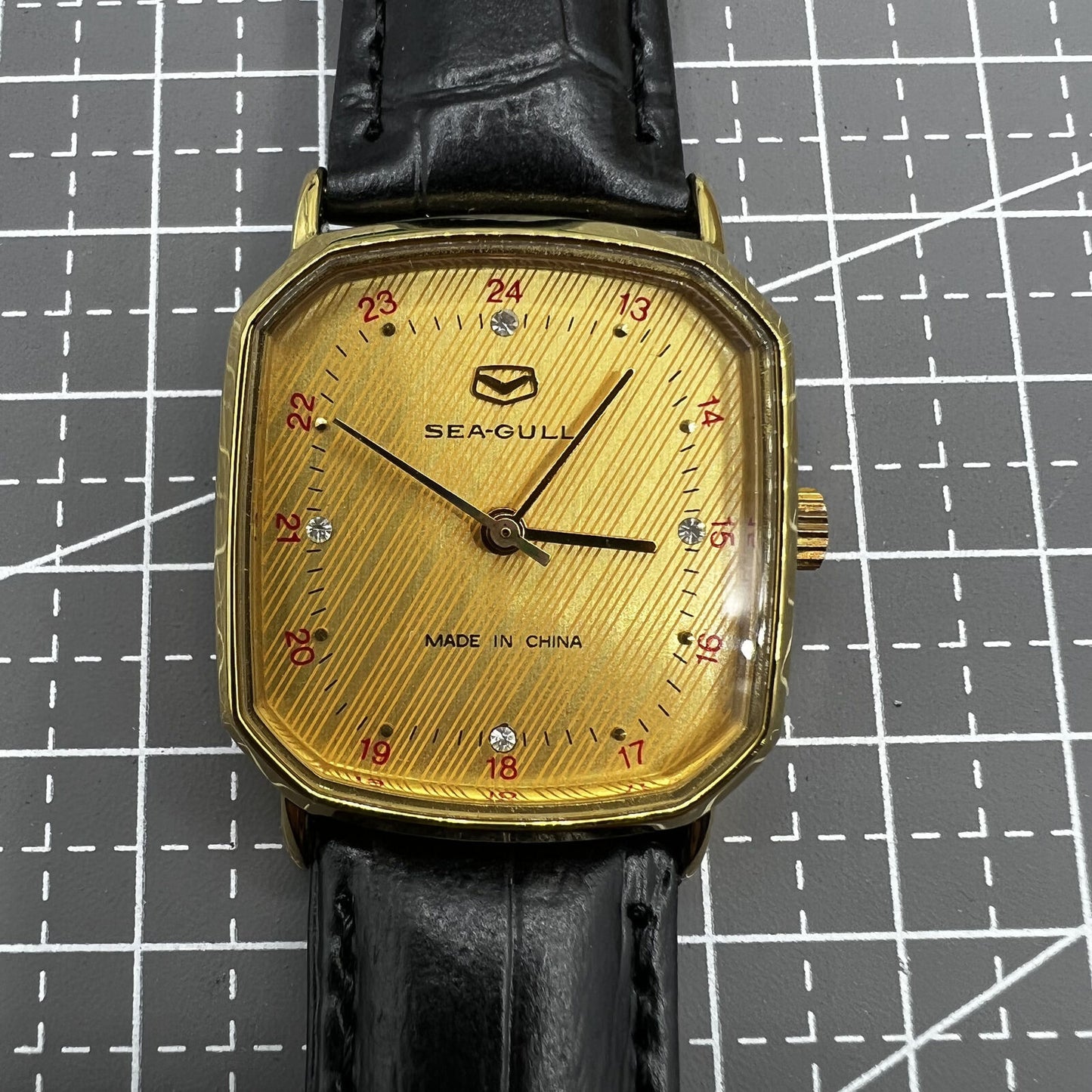 28mm Tianjin Seagull watch with octagonal gold case and golden dial, manual mechanical movement precision.