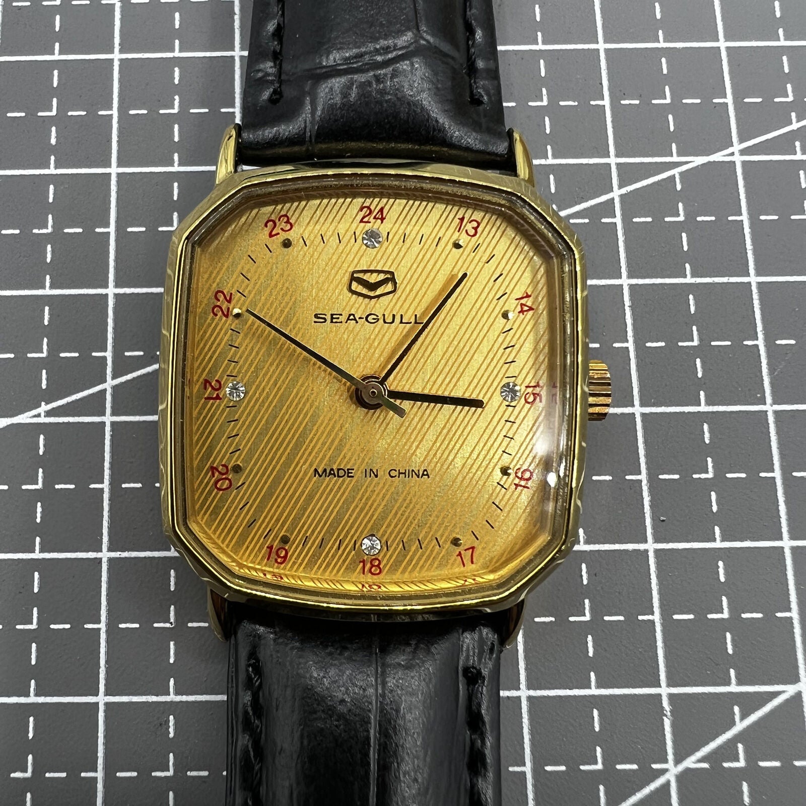 28mm Tianjin Seagull watch with octagonal gold case and golden dial, manual mechanical movement precision.