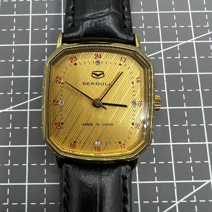 28mm Tianjin Seagull watch with octagonal gold case and golden dial, manual mechanical movement precision.