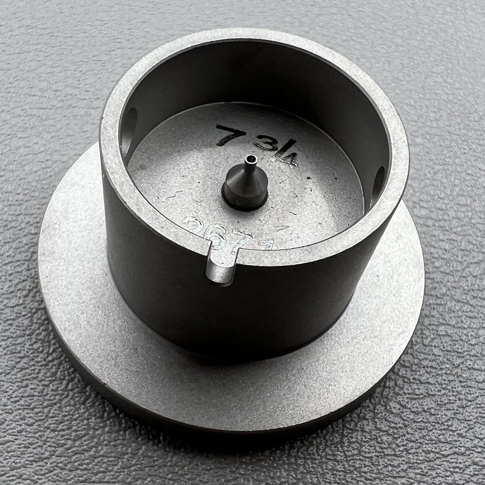 Size 7-3/4 ligne ETA 2671 movement holder with center screw, secure watch repair.